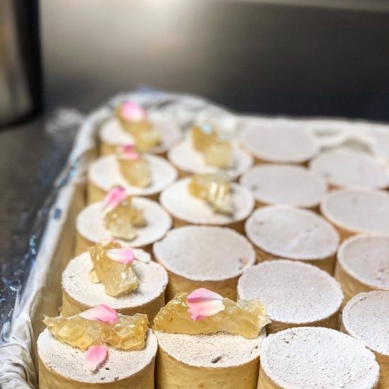 Yellow Desserts with Powdered Sugar and Pink Petals