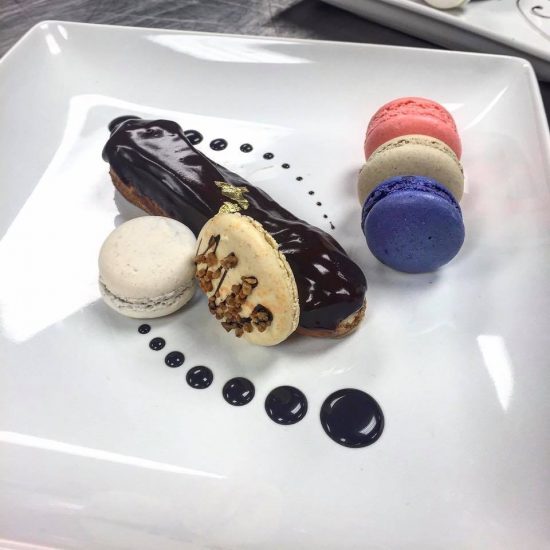 Plated Dessert with Macarons and Eclair